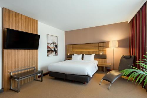 a hotel room with two beds and a television at Radisson Blu Hotel Krakow in Krakow