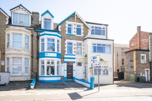 a building with blue and white trim on a street at The Adonis Hotel in Blackpool