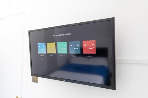 a flat screen tv with a program on it at The Adonis Hotel in Blackpool