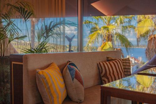 a couch with pillows on it in a restaurant at Montargil Monte Novo in Montargil