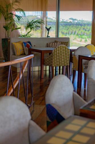 a living room with a table and chairs and a couch at Montargil Monte Novo in Montargil