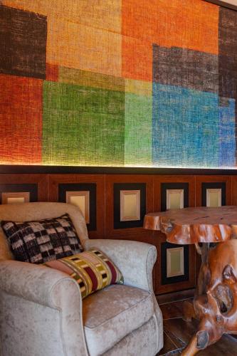 a room with a couch and a table and a colorful wall at Montargil Monte Novo in Montargil