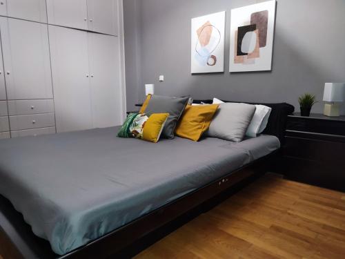 a bed with yellow pillows on it in a bedroom at Euphoria Apartment in Nafplio