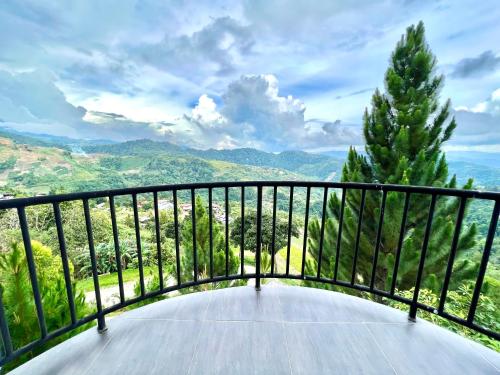 a balcony with a view of the mountains at JR RESORT in Ranau