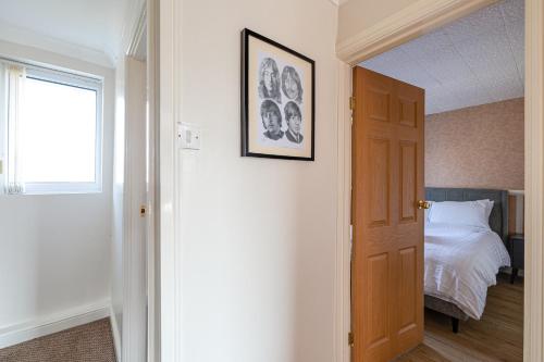 a room with a bedroom with a bed and a window at George Harrison's Former 3Bed Home in Liverpool in Speke
