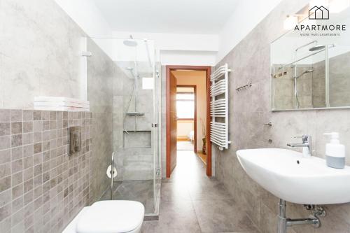 a bathroom with a sink and a toilet and a shower at City Center - Torunska 18 by Apartmore in Gdańsk
