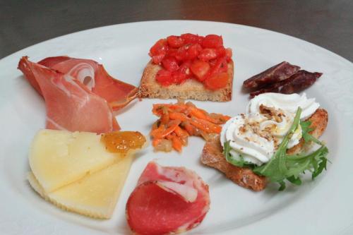 a white plate with different types of food on it at Il Casino di Remartello in Loreto Aprutino