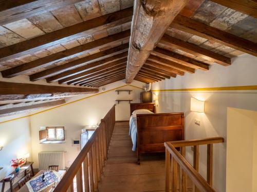 a staircase in a room with wooden ceilings at Villa Borgo San Pietro in Cortona
