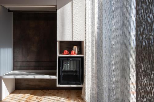 a living room with a fireplace and a curtain at La Cipressina B&B in Cavaion Veronese