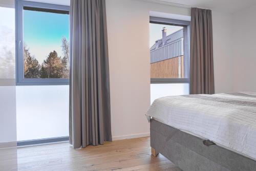 Posteľ alebo postele v izbe v ubytovaní TATRYSTAY Brezy Luxury Apartment