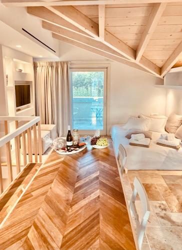 a bedroom with a bed and a table with drinks on it at Carpofoli Corfu Town Serviced Luxury Suites in Corfu