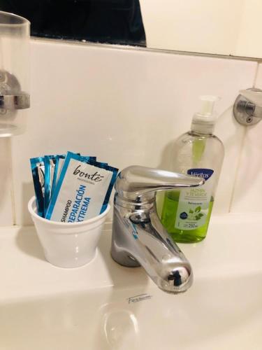 a sink with a faucet and a bottle of toothpaste at Aires Verdes de Salta in Salta