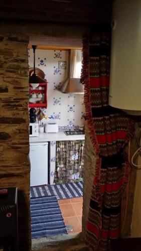 a view of a kitchen through a doorway at Casinha de Xisto - Serra do Açor in Benfeita