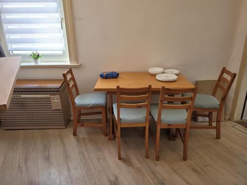 a dining room table and chairs with a table and a window at Günstige Monteurwohnung in Bad Grund in Bad Grund