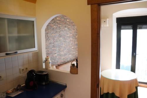 cocina con fregadero y espejo en la pared en Apartamentos Las Buganvillas, en Cáceres