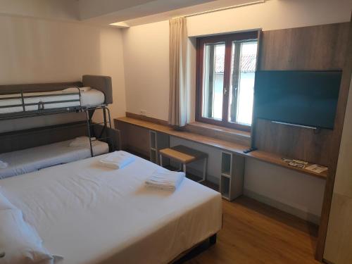 Postel nebo postele na pokoji v ubytování Albergo Baschera
