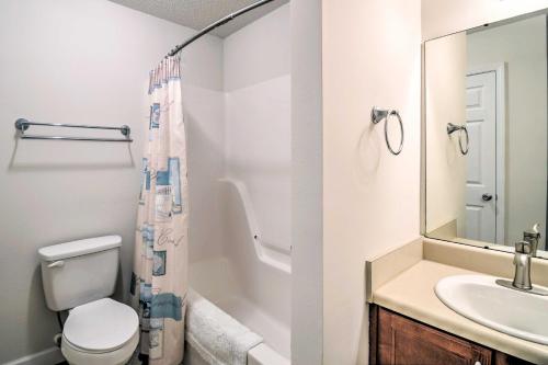 a bathroom with a sink and a toilet and a mirror at Foley Getaway with Fenced Yard - 13 Mi to Beaches! in Foley