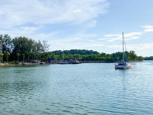 a boat floating on a large body of water at BayView Suites Port Dickson By MAISON in Port Dickson