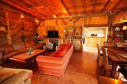 a living room with a couch and a table in a cabin at Bamboo Lodge Groningen in Groningen