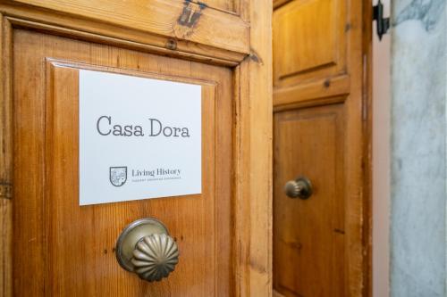 a wooden door with a sign on it at LH-Casa Dora in Pisa