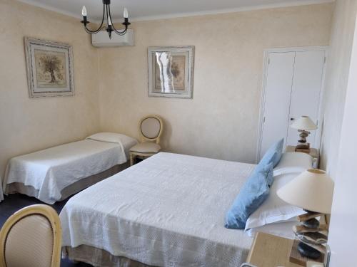 a bedroom with two beds and a window at STELLA MARE in Algajola