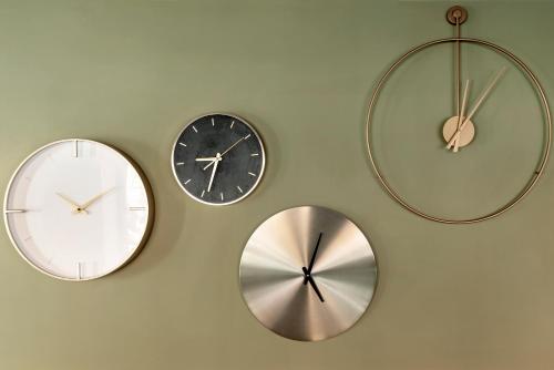 a group of three clocks on a wall at Hotel Parker - Gruppo BLAM HOTELS in Rome