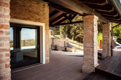 an open door to a brick building with a patio at Resort Villa Paola in Longiano