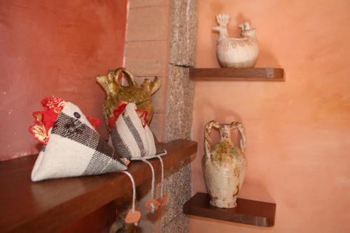 a shelf with some shoes and some vases on it at B&B Sa Madalena a Dorgali-IUN E4918 in Dorgali