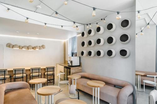 a restaurant with tables and stools in a room at Ribas Rooms Lutsk in Luts'k