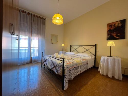 a bedroom with a bed with a table and a lamp at Appartamenti Villacedro in Lazise