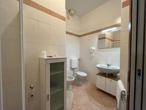 a bathroom with a toilet and a sink at Appartamenti Villacedro in Lazise