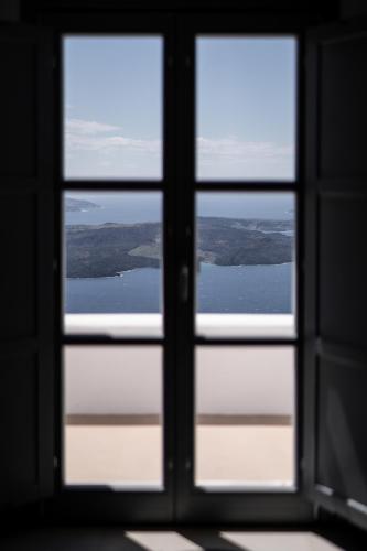 a view from a window looking out at the water at Imera Vista Suites in Imerovigli