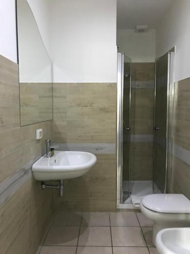 a bathroom with a sink and a shower and a toilet at Acquarium Tropea in Tropea