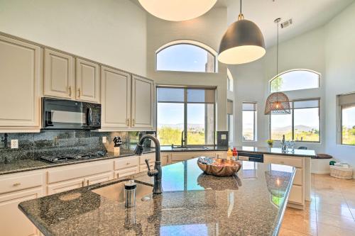 a kitchen with white cabinets and a counter top at Pool, Spa and Putting Green Fountain Hills Home! in Fountain Hills