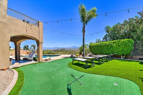 a golf course with a green with a table and benches at Pool, Spa and Putting Green Fountain Hills Home! in Fountain Hills