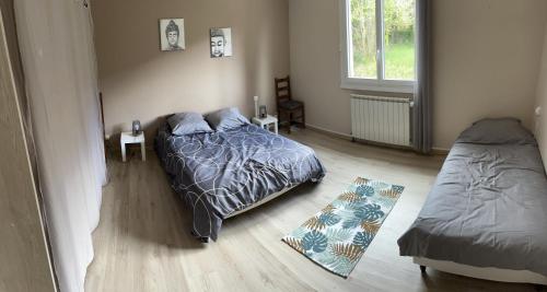 a bedroom with a bed and a rug on the floor at Villa avec piscine dans Vallon Pont d’Arc in Vallon-Pont-dʼArc