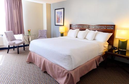 a hotel room with two beds and a table at Rodd Grand Yarmouth in Yarmouth
