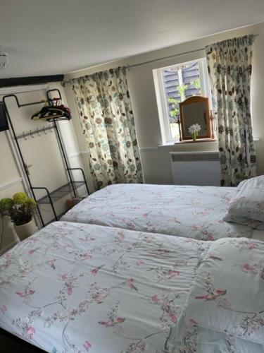 a bedroom with a bed and a window at The Red Lion Great Offley in Offley