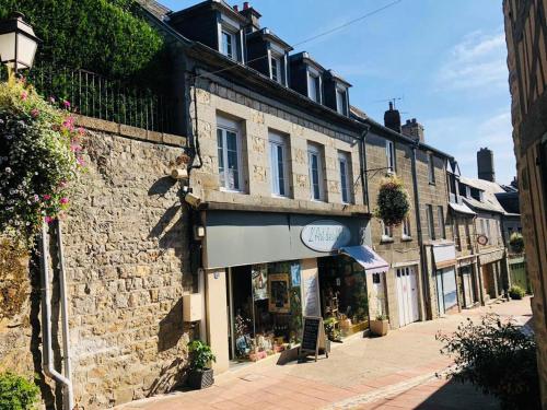 a brick building with a store on a street at A La Maison - hébergement de luxe in Domfront