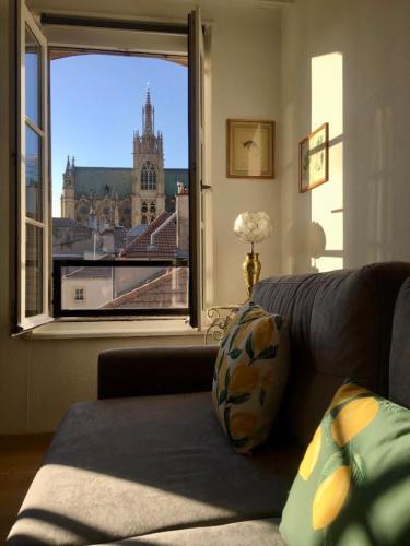 - un salon avec vue sur une grande fenêtre dans l'établissement Au Fil du Temps, à Metz