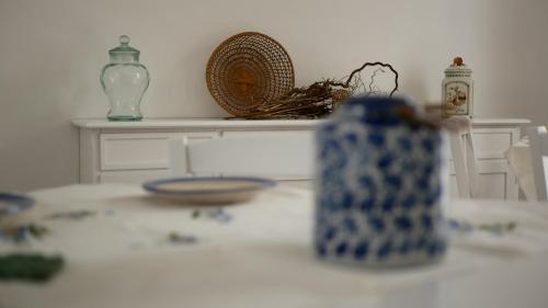a table with blue and white vases on it at Palazzo Donna Chicchi in Galatone