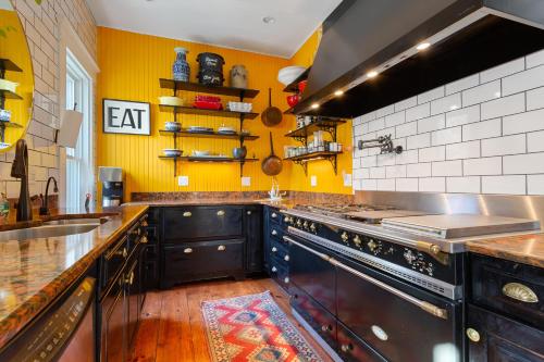 
a kitchen with a stove top oven and a sink at Stowaway in Provincetown
