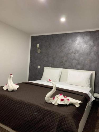 a bedroom with a bed with swans on it at La Zinculescu in Albeştii Pămînteni