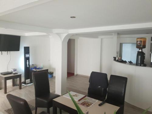 a living room with a table and chairs and a room with at La Zinculescu in Albeştii Pămînteni