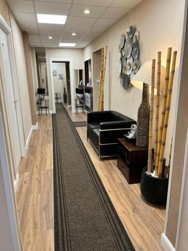 a living room with a black couch and a table at Domus La Foce Hotel self check in in Genova