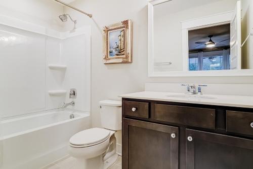 a white bathroom with a toilet and a sink at Hammock Breeze 21 in Hilton Head Island