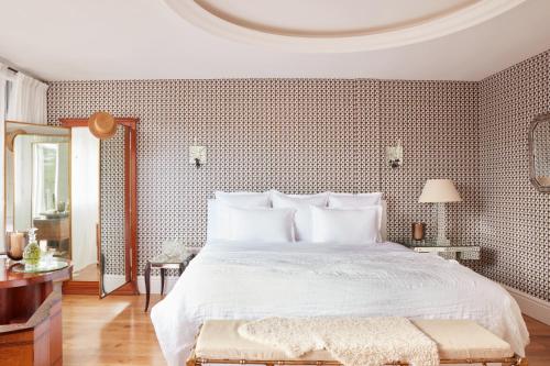 a bedroom with a large bed with a white bedspread at Brindos, Lac & Château - Relais & Châteaux - Anglet Biarritz in Anglet