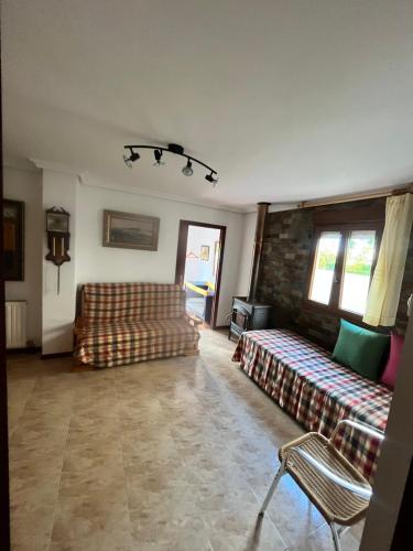 a living room with two couches and a couch at Liencres tranquilo con piscina comunitaria in Liencres