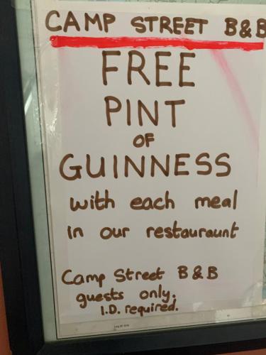 a sign that reads camp street can be a free pint of guinness with each at Room 1 Camp Street B&B in Oughterard