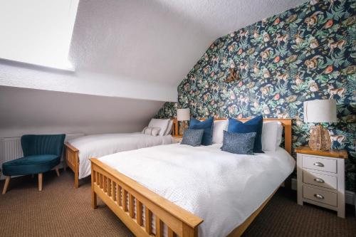 a bedroom with two beds and a wall mural at Glen Wynne Windermere - FREE off-site Health Club access with Pool, Sauna, Steam Room & Gym Short 5 Minute Drive Away in Windermere